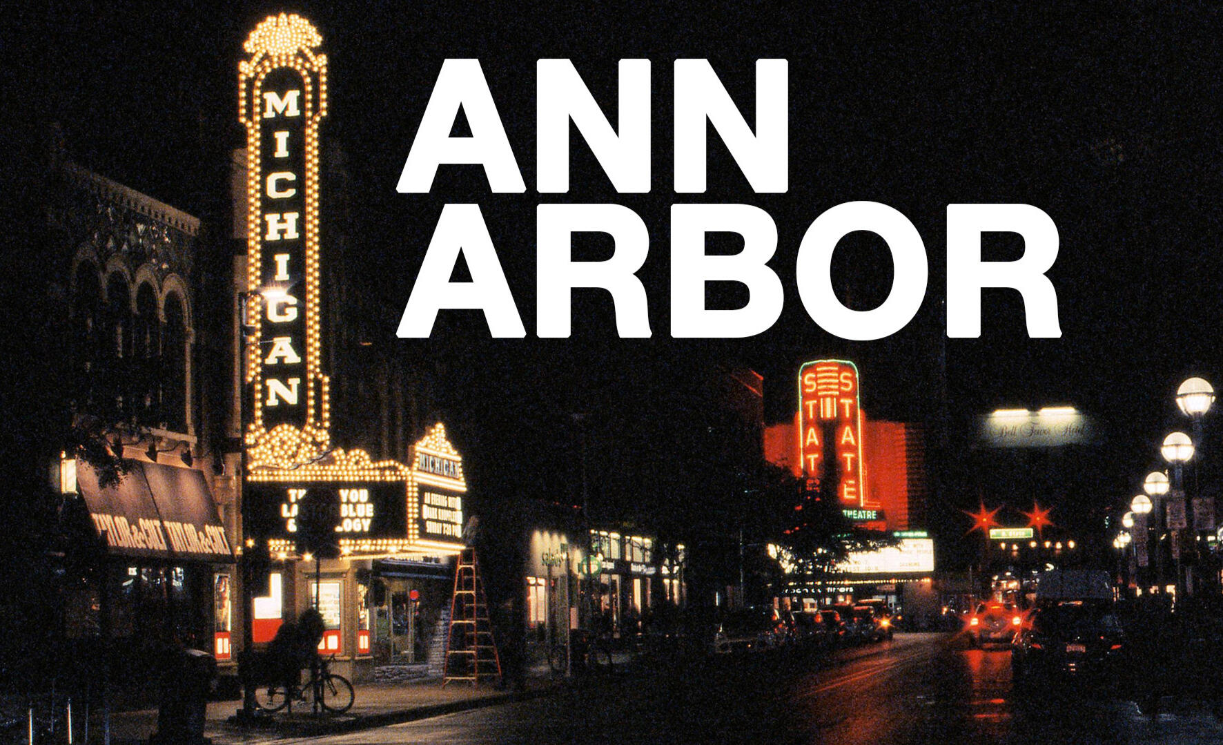 Ann Arbor Poster A night image of the Michigan Theater with the State Theater in the background shot on 35mm film with visible grain and "Ann Arbor" in white block letters.